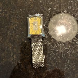 Invicta silver with yellow face watch.